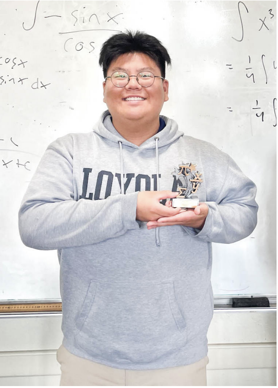 YI POSING with his Integration Bee trophy